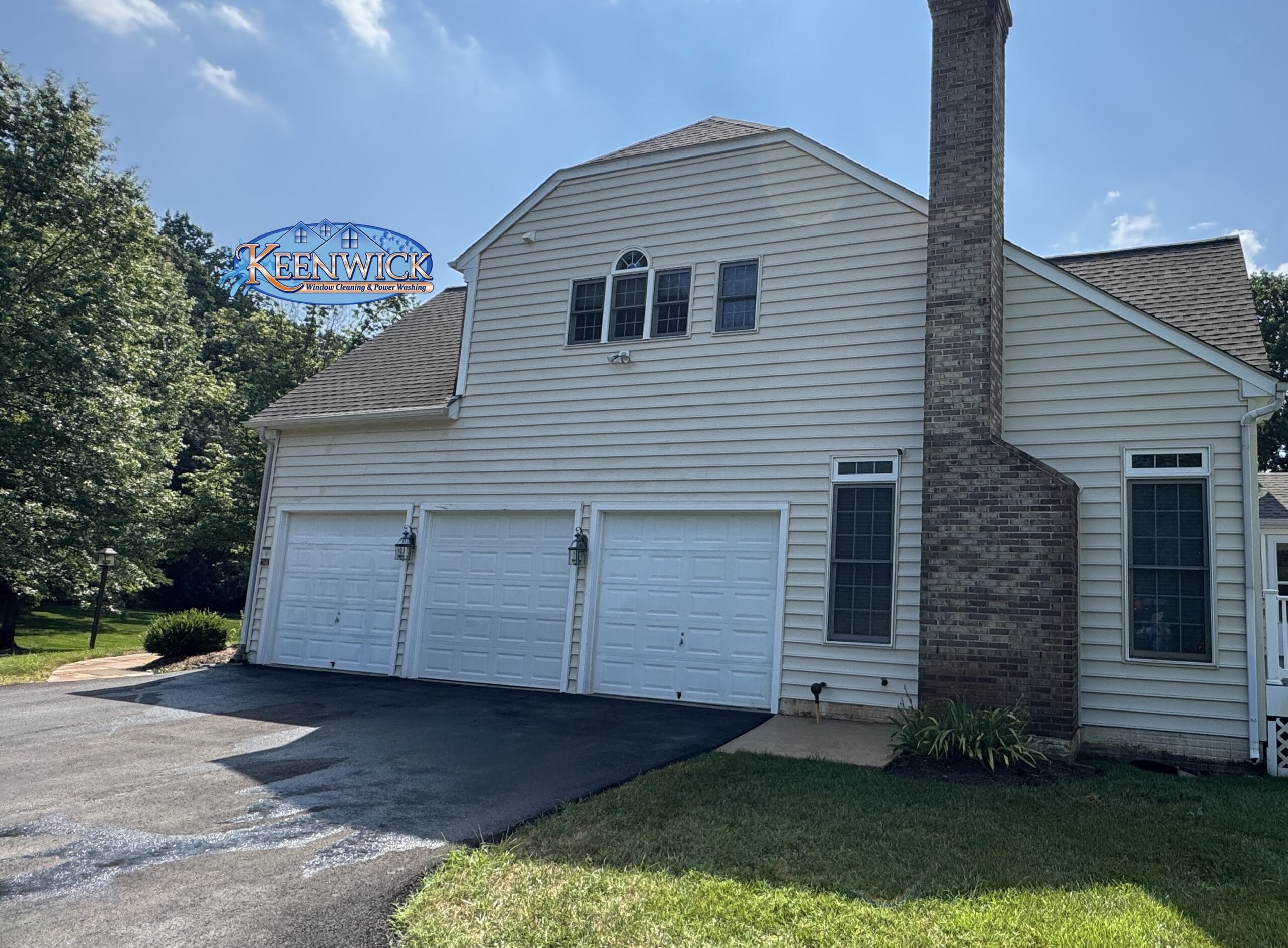 Residential home exterior after soft washing, clean siding and roof