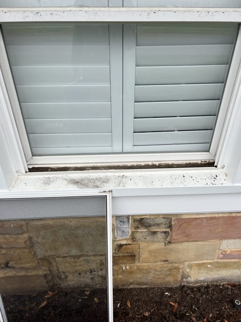 Window and sill before residential window cleaning